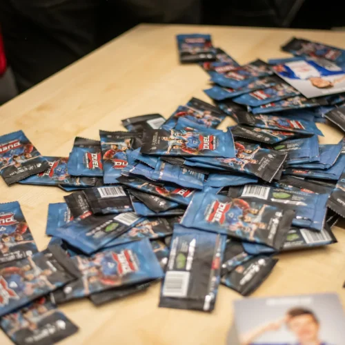 Na zdjęciu znajduje się rozłożona na stole sterta paczek z grami „Duel”.